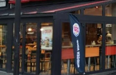Burger King restaurant building showing storefront design, branding, and dining area from the street view