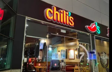 Chili’s restaurant building at the mall with illuminated signage and glass entrance