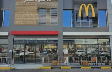 McDonald's restaurant building at Woqod Al Hilal featuring a modern exterior facade with the iconic Golden Arches logo